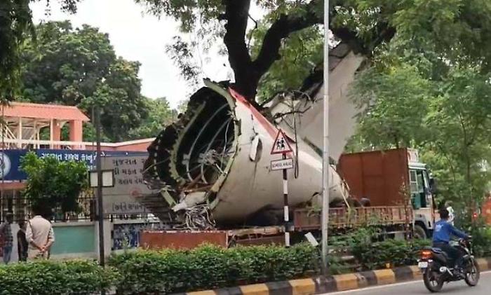 Schianto volo Air India AI171, camion con il relitto del Boeing 787 resta incastrato  in una pianta nel quartiere di Shahibaug a Ahmedabad